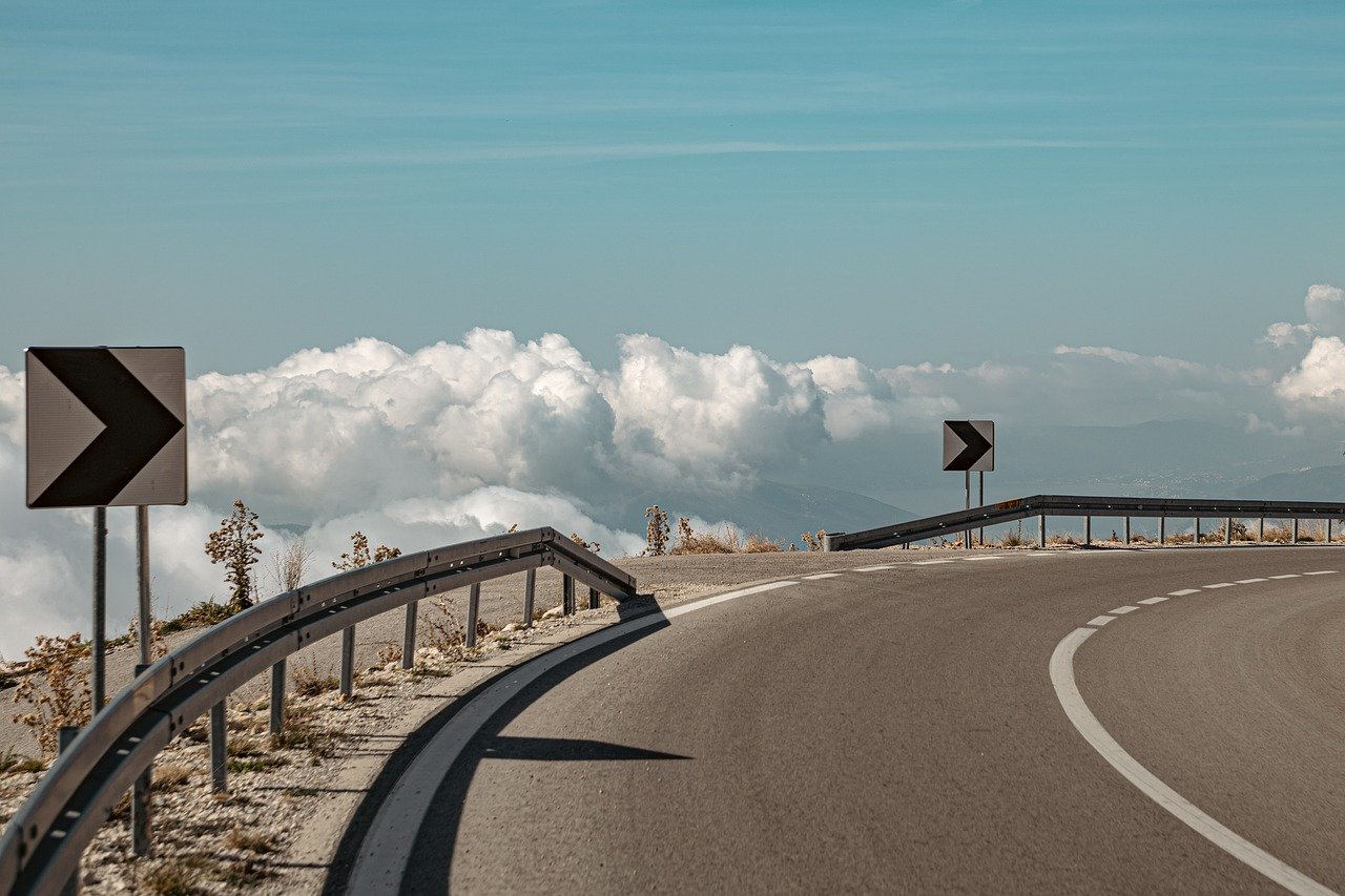 road sign arrow clouds sky 8410533